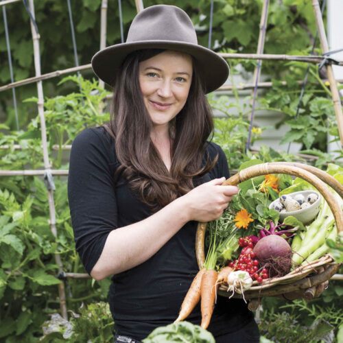 Urban gardener Kat Laver with a basket of her homegrown vegetables.
