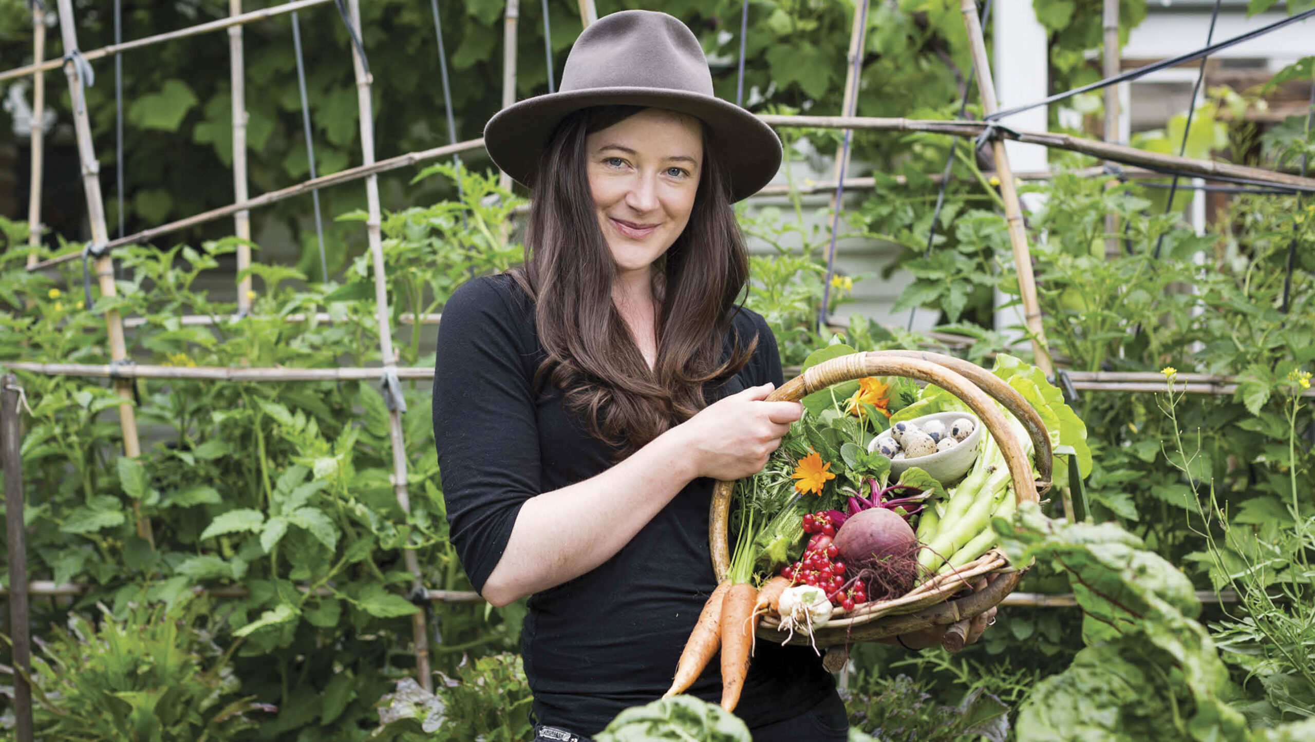 Urban gardener Kat Laver with a basket of her homegrown vegetables.