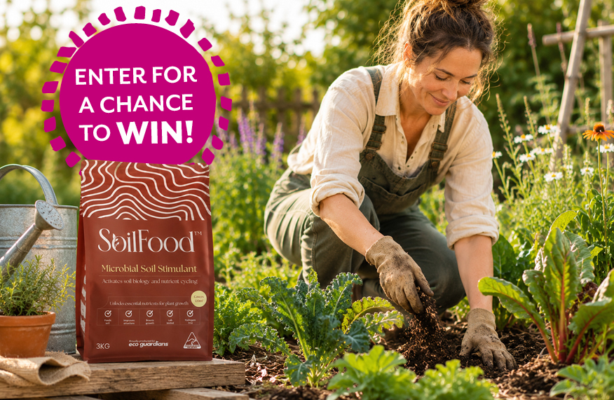 Women in garden beside a bag of SoilFood soil conditioner